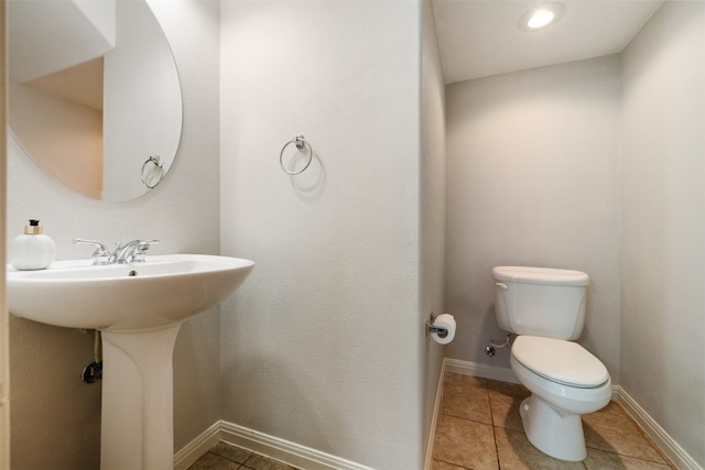 bathroom featuring toilet and tile patterned flooring