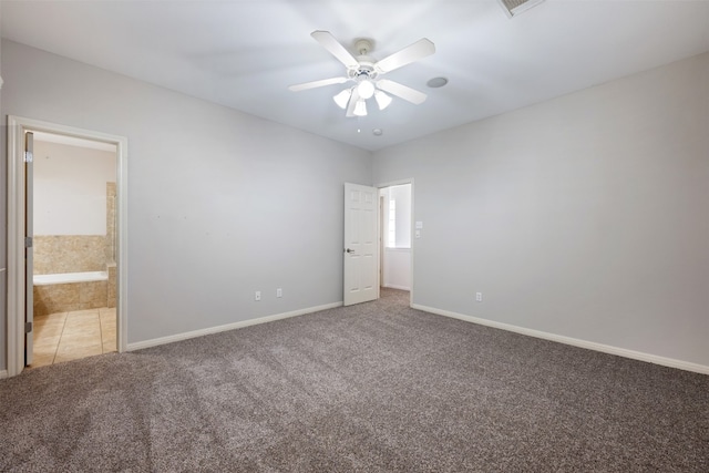 unfurnished bedroom featuring ensuite bathroom, ceiling fan, and carpet