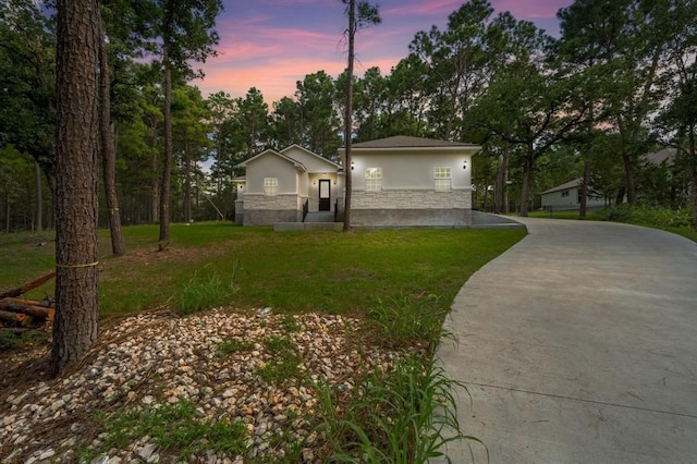 ranch-style house featuring a yard and a garage