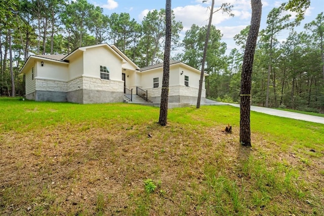 view of home's exterior with a lawn