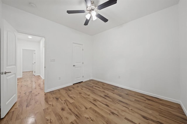 spare room featuring light wood-type flooring and ceiling fan