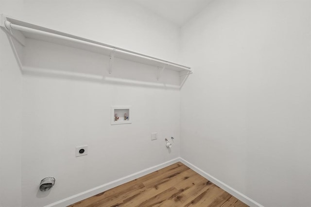 laundry room featuring electric dryer hookup, hardwood / wood-style floors, hookup for a washing machine, and gas dryer hookup