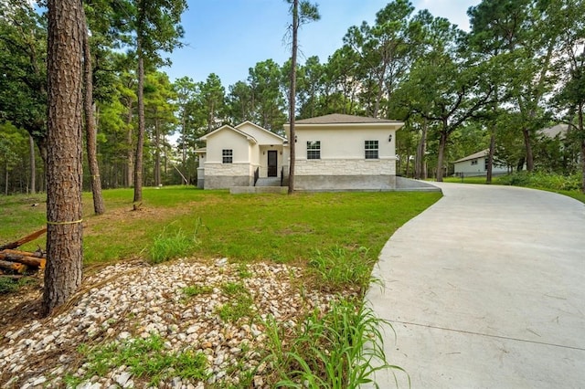 view of front of house featuring a garage and a front lawn