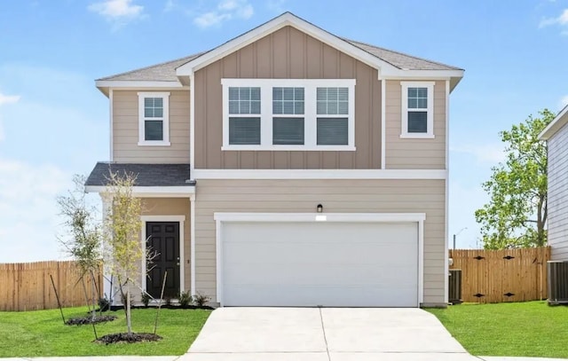 view of front of property featuring a front yard and a garage