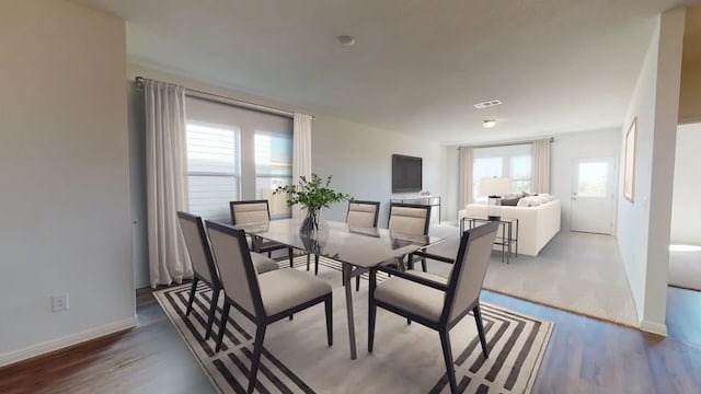 dining space with wood-type flooring