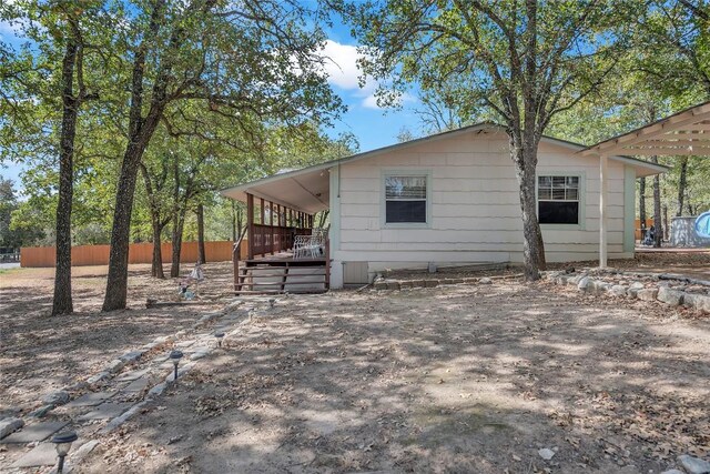 view of side of property featuring fence