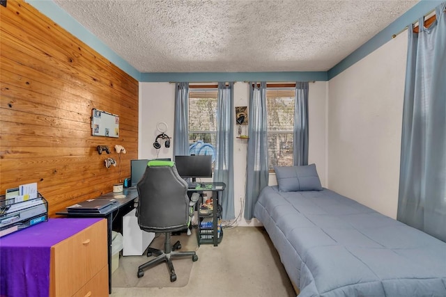 320 Pope Bnd S, Cedar Creek, TX 78612 - bedroom with a textured ceiling, a desk, and wood walls