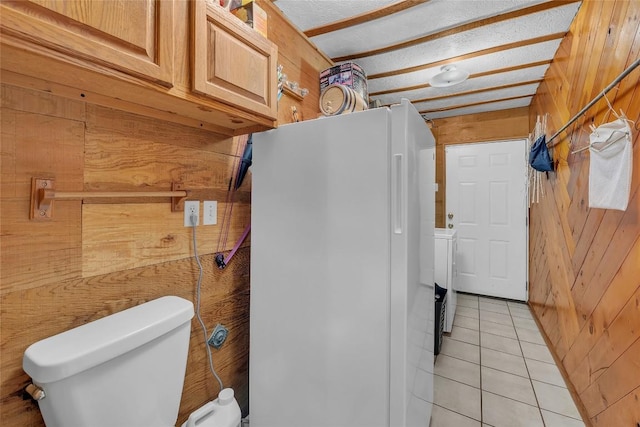 320 Pope Bnd S, Cedar Creek, TX 78612 - bathroom featuring wooden walls, tile patterned flooring, and washer / clothes dryer