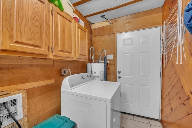 320 Pope Bnd S, Cedar Creek, TX 78612 - washroom with washer / clothes dryer, wood walls, cabinet space, and water heater