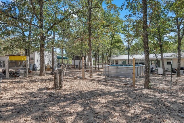 view of yard with fence and a fenced in pool