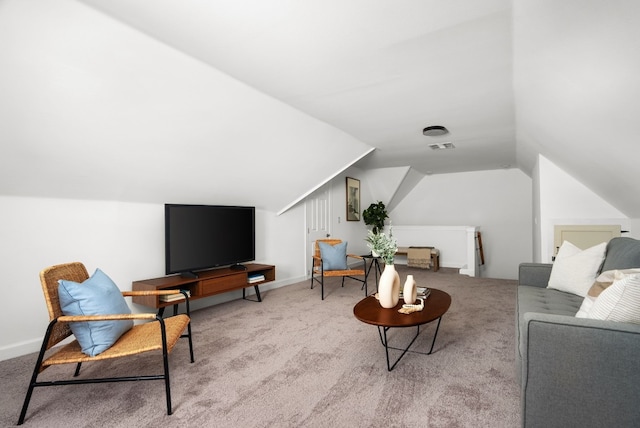 living room with vaulted ceiling and light colored carpet