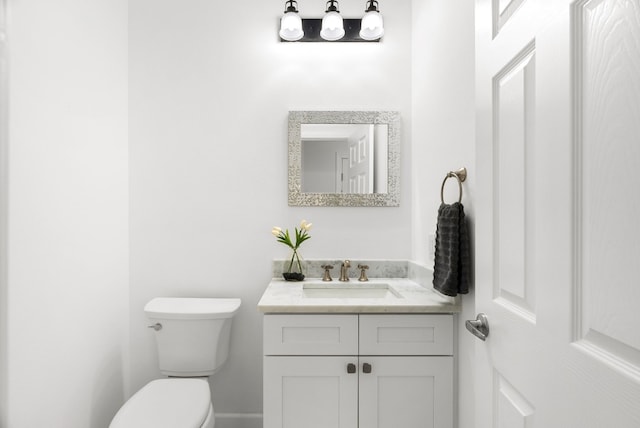 bathroom with toilet and vanity