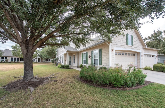 view of front of house with a front yard and a garage