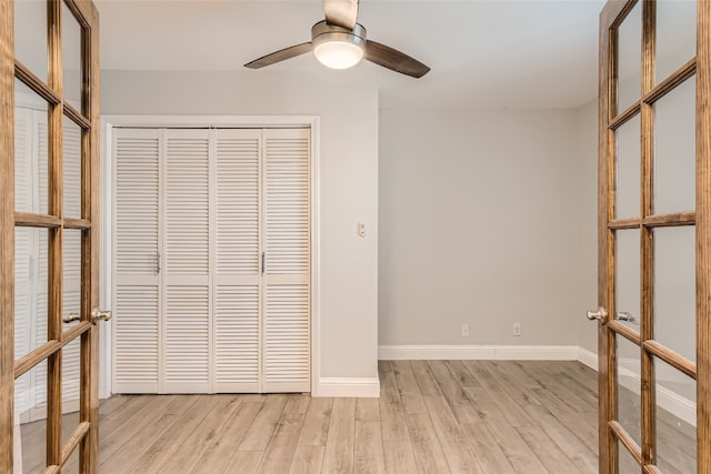 unfurnished bedroom with light hardwood / wood-style flooring, french doors, a closet, and ceiling fan