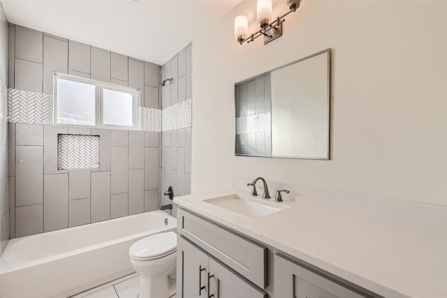 full bathroom featuring tiled shower / bath, vanity, toilet, and tile patterned flooring