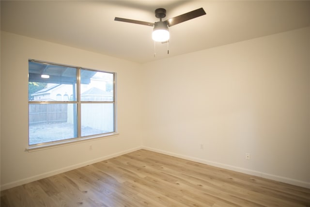 empty room featuring light wood-type flooring and ceiling fan