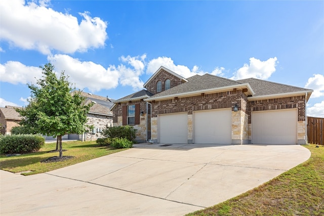 view of front of property featuring a front yard and a garage