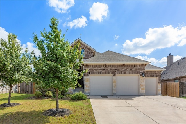 view of front of home featuring a garage and a front lawn