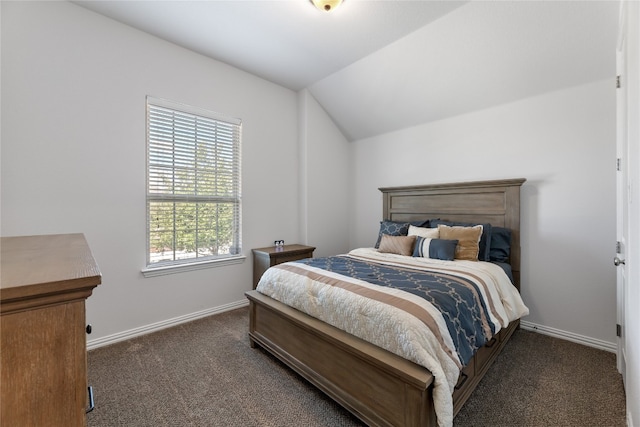 bedroom with vaulted ceiling and dark colored carpet