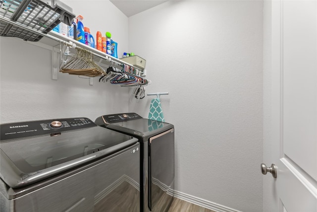 washroom featuring washer and clothes dryer and hardwood / wood-style flooring