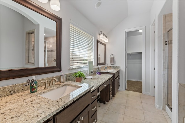 bathroom featuring tile patterned floors, vanity, an enclosed shower, and lofted ceiling