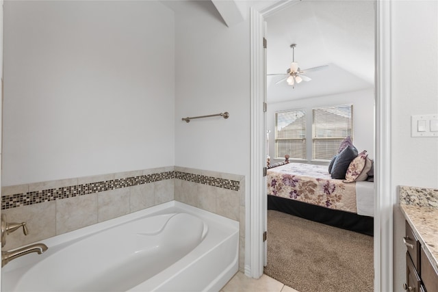 bathroom with tile patterned floors, vanity, ceiling fan, and a bath