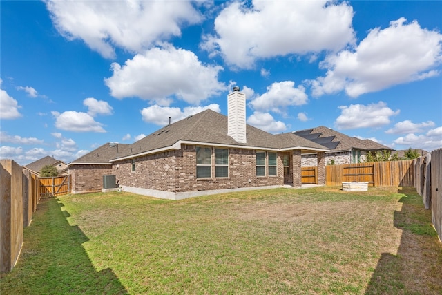 rear view of house with a yard