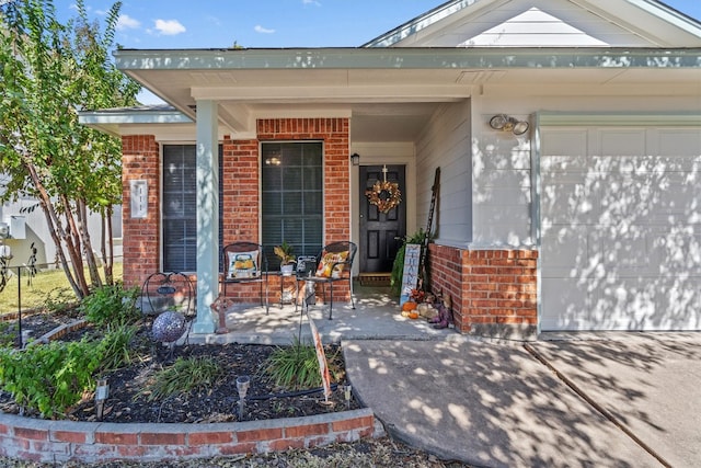 view of exterior entry with a garage and covered porch