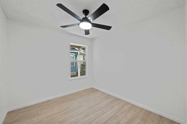 empty room featuring light hardwood / wood-style floors, a textured ceiling, and ceiling fan