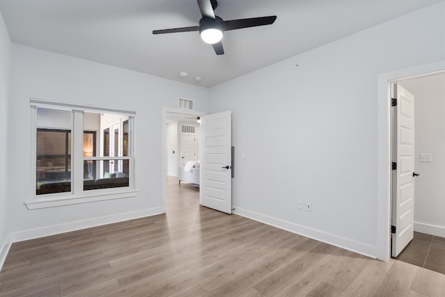 unfurnished bedroom with ceiling fan and wood-type flooring