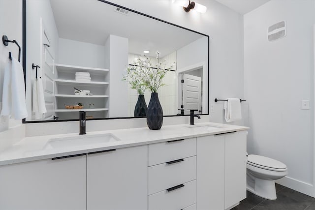 bathroom featuring tile patterned flooring, vanity, and toilet