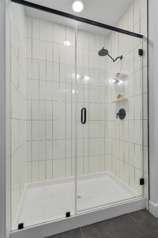 bathroom with tile patterned floors and a shower with shower door