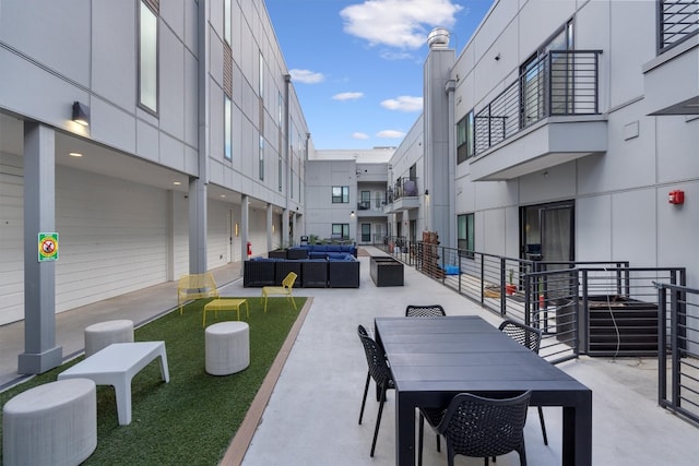 view of home's community featuring a patio area and an outdoor hangout area