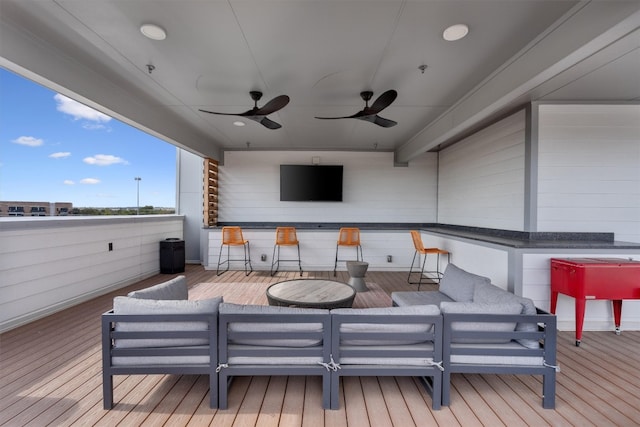 wooden terrace featuring an outdoor living space and ceiling fan