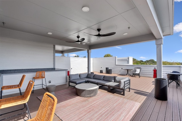 wooden deck featuring ceiling fan and an outdoor hangout area