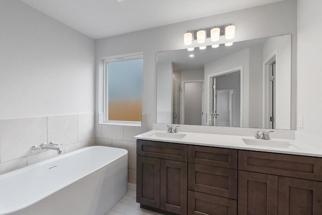 bathroom with tile patterned floors, vanity, plus walk in shower, and tile walls