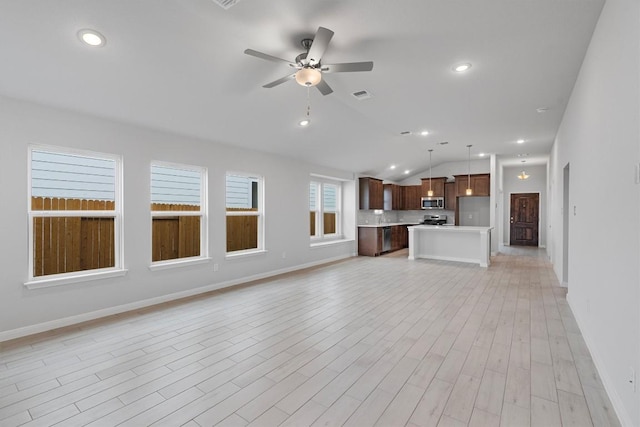 unfurnished living room with ceiling fan, light wood-type flooring, and lofted ceiling