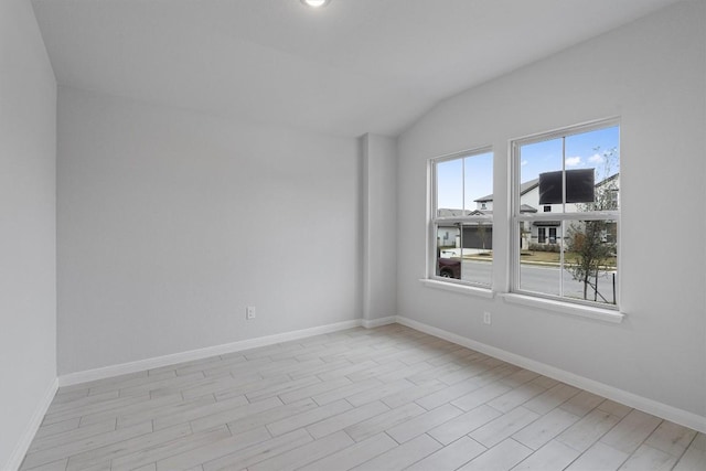 spare room featuring lofted ceiling