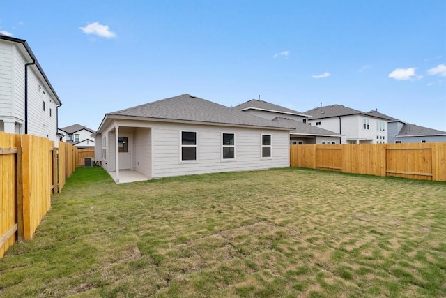 back of property featuring a yard and central air condition unit