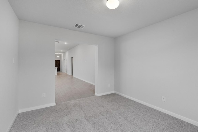 empty room featuring light colored carpet