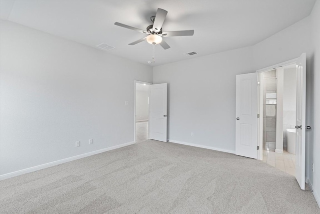 unfurnished bedroom with connected bathroom, ceiling fan, and light colored carpet