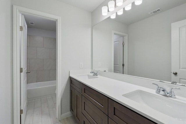 full bathroom featuring vanity, toilet, and tiled shower / bath