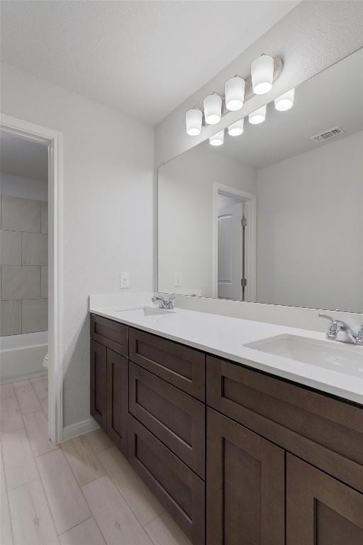 full bathroom with vanity, toilet, and tub / shower combination