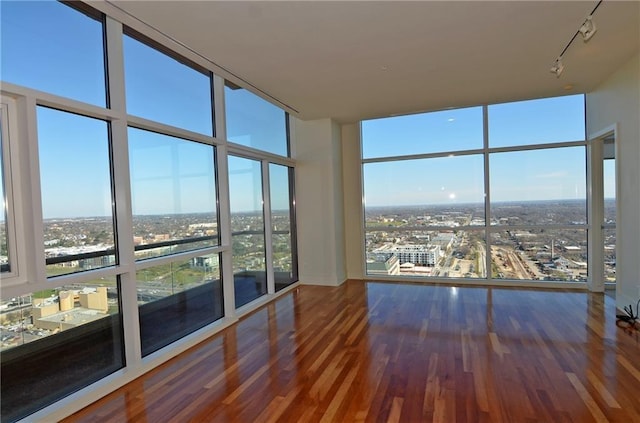 interior space with hardwood / wood-style flooring and a wall of windows