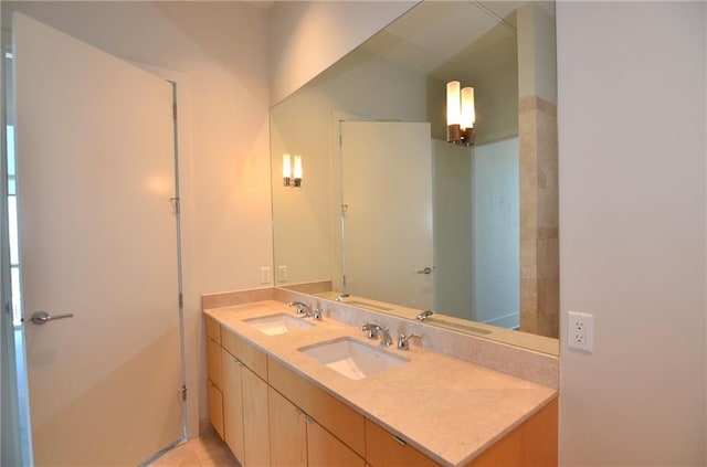 bathroom featuring tile patterned flooring and vanity