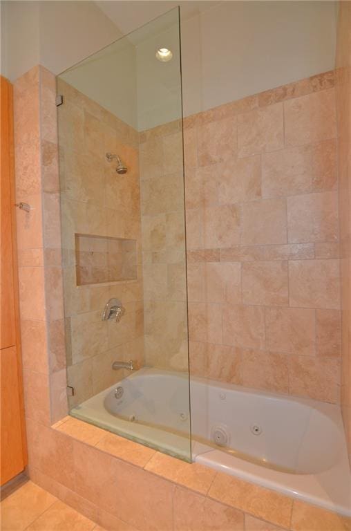 bathroom featuring tiled shower / bath combo and tile patterned floors