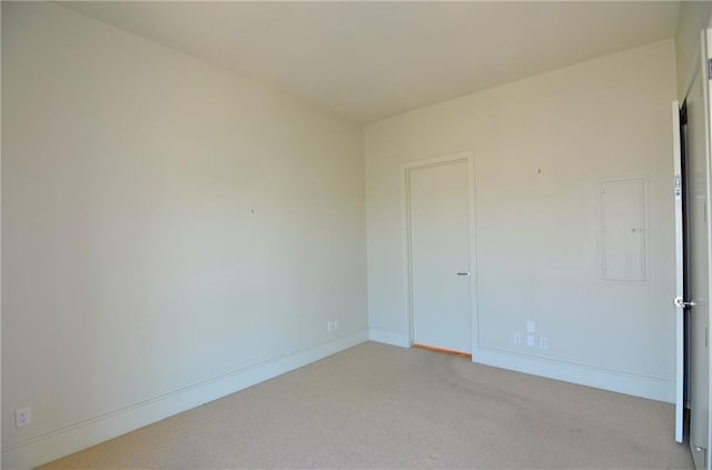 carpeted spare room featuring electric panel