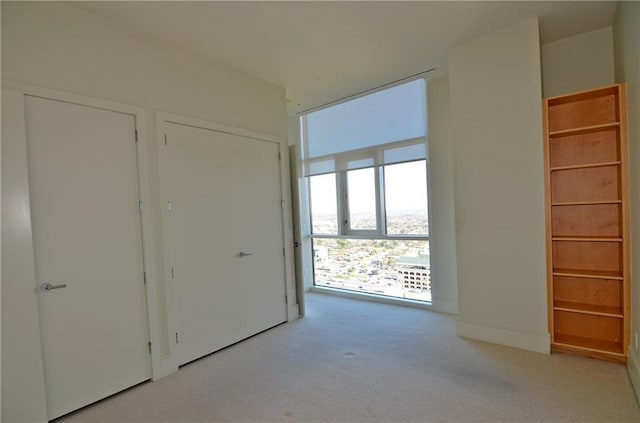 unfurnished bedroom featuring light colored carpet