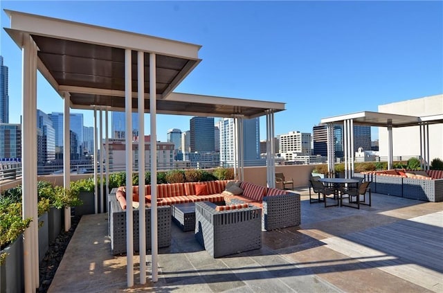 view of patio with an outdoor living space with a fire pit