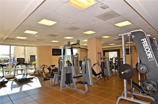 workout area with a paneled ceiling